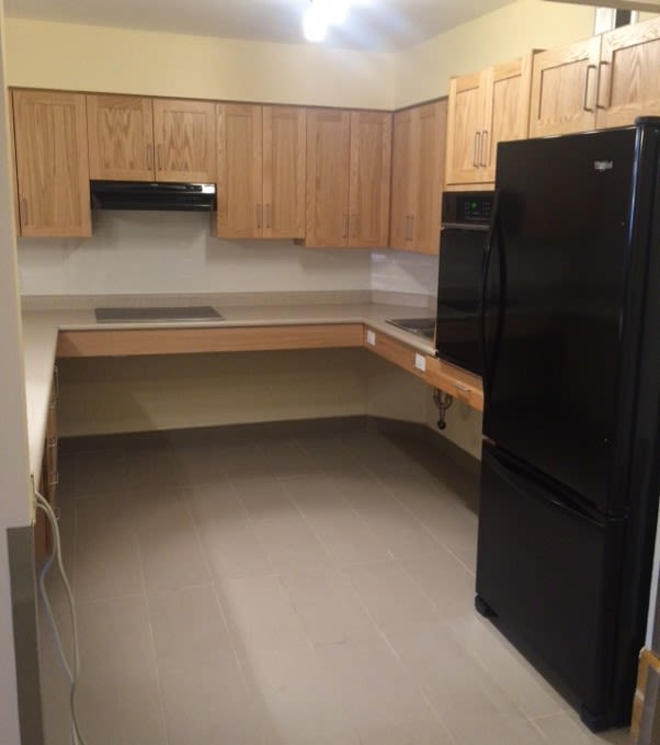An accessible kitchen with lowered countertops, appliances and electrical plugs.
