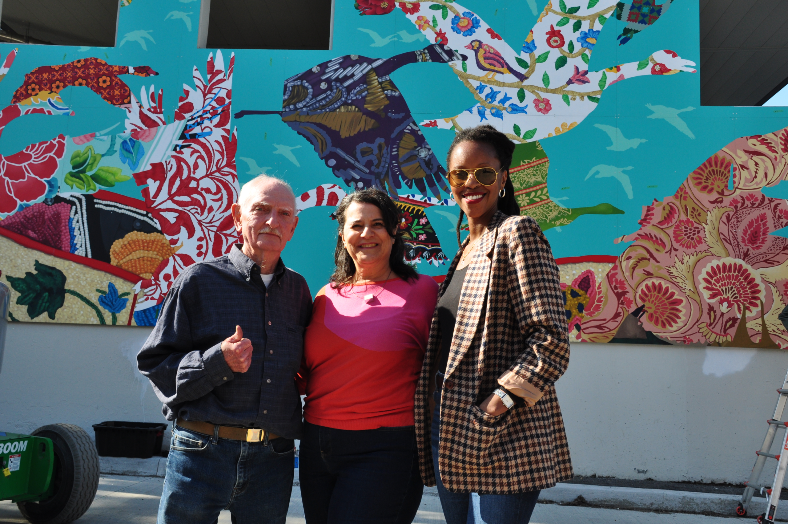 photo of three alexandra park residents in front of mural on 20 Vanauley