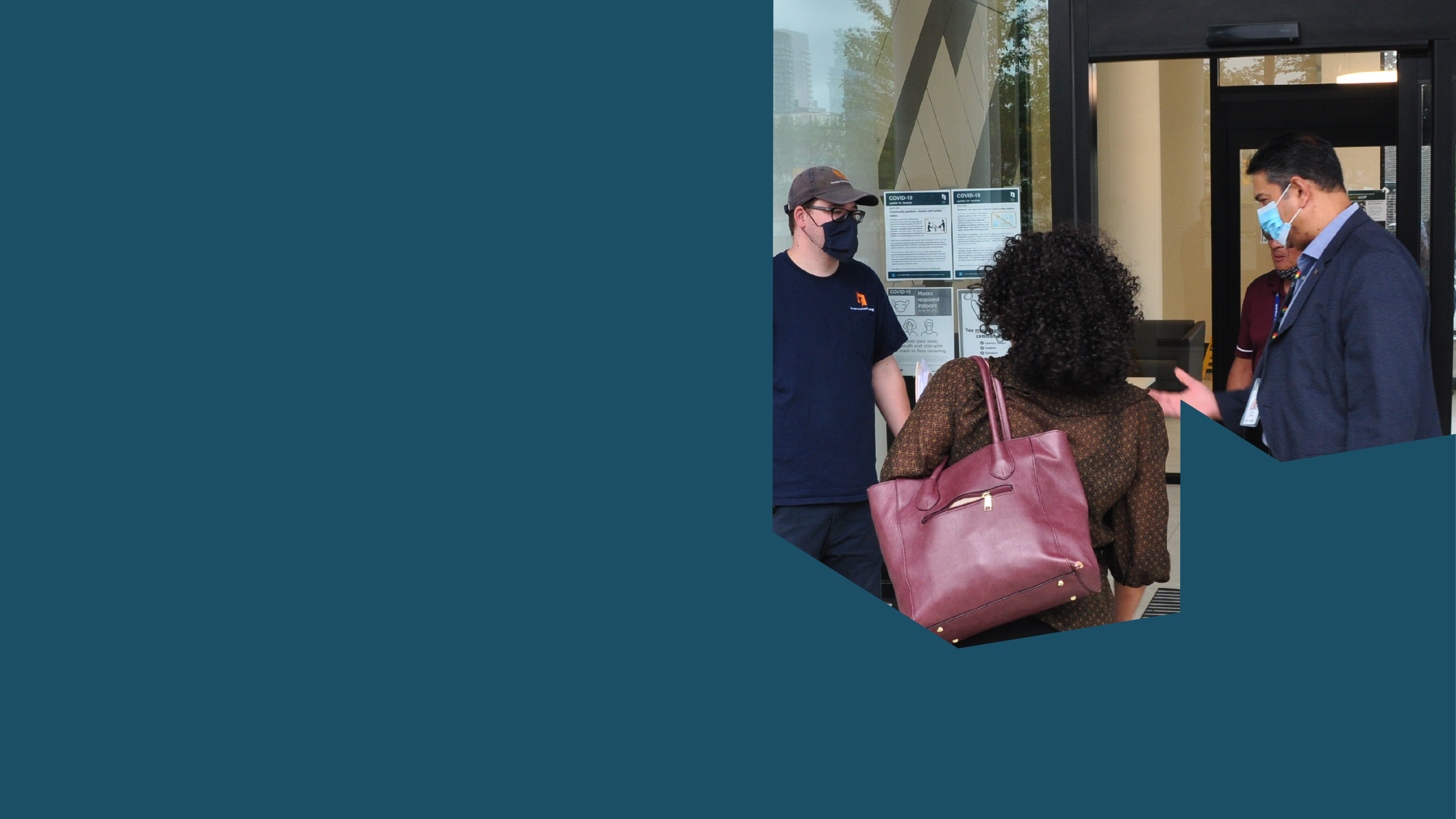 A group of people standing in front of a Tenant Service Hub.