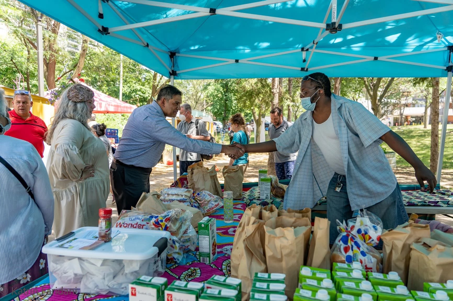 Person shaking other person's hand at market