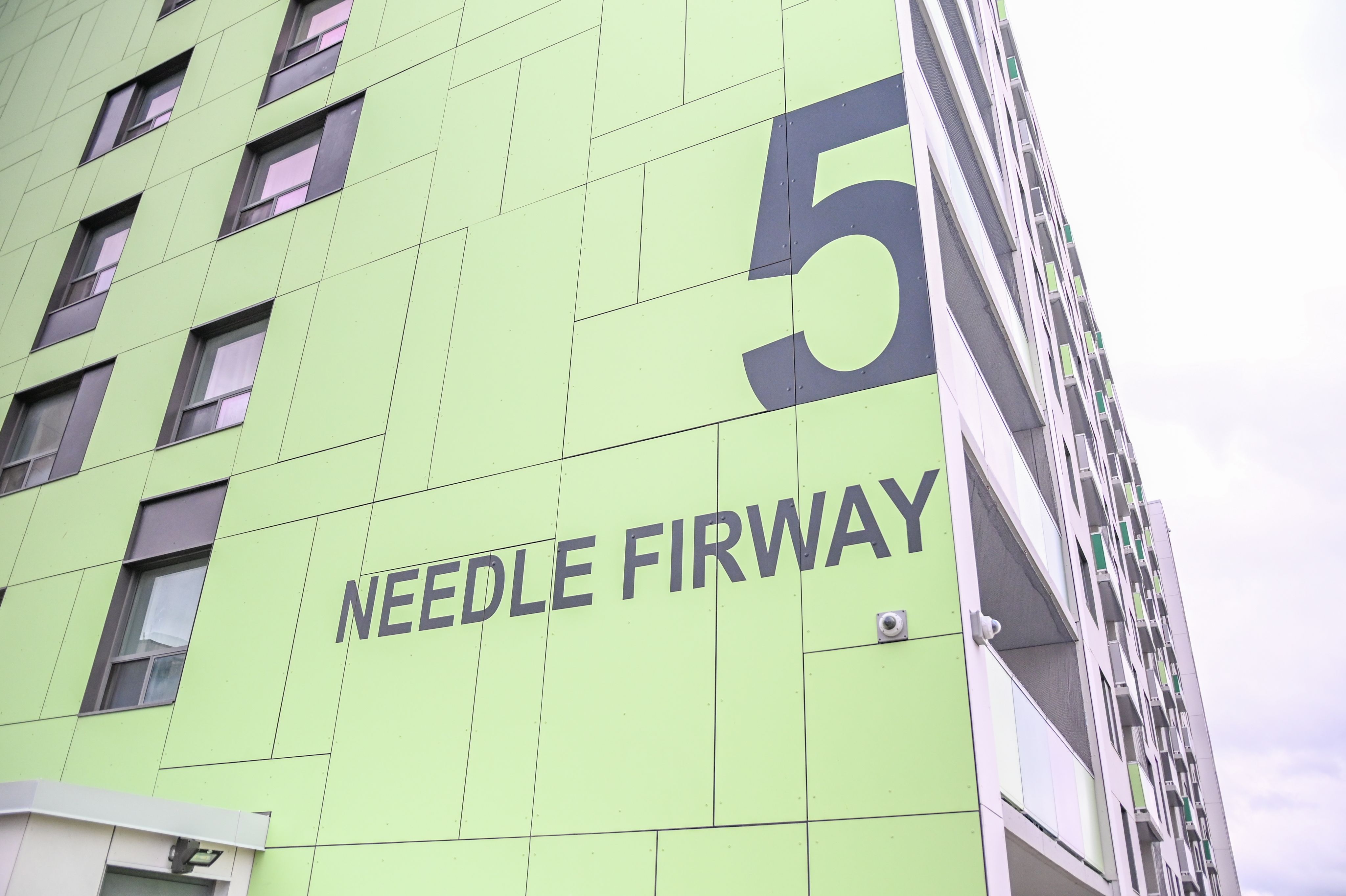 Photo of building with writing on it that says "5 Needle Firway"