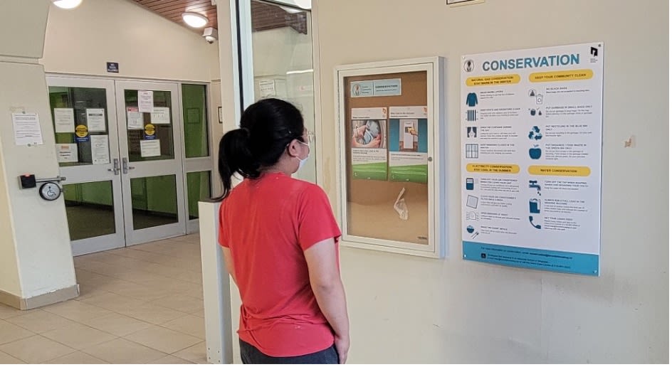 Person looking at a conservation bulletin board