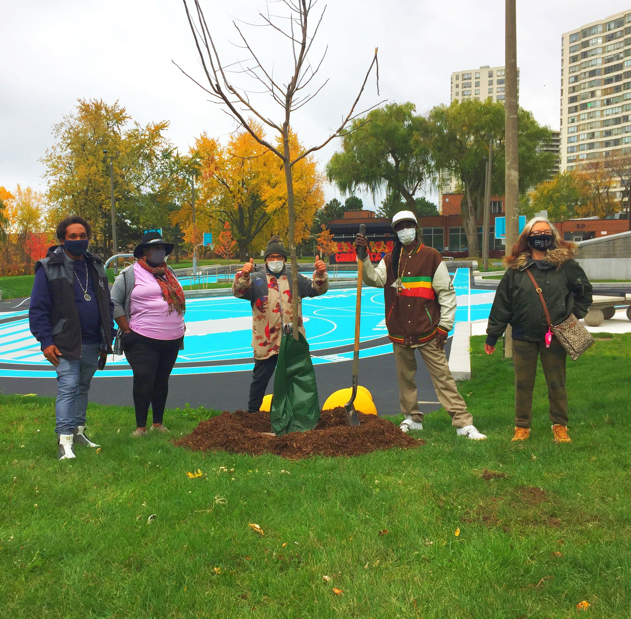 photo of Gordonridge tenants successfully planting a tree and cheering a tree