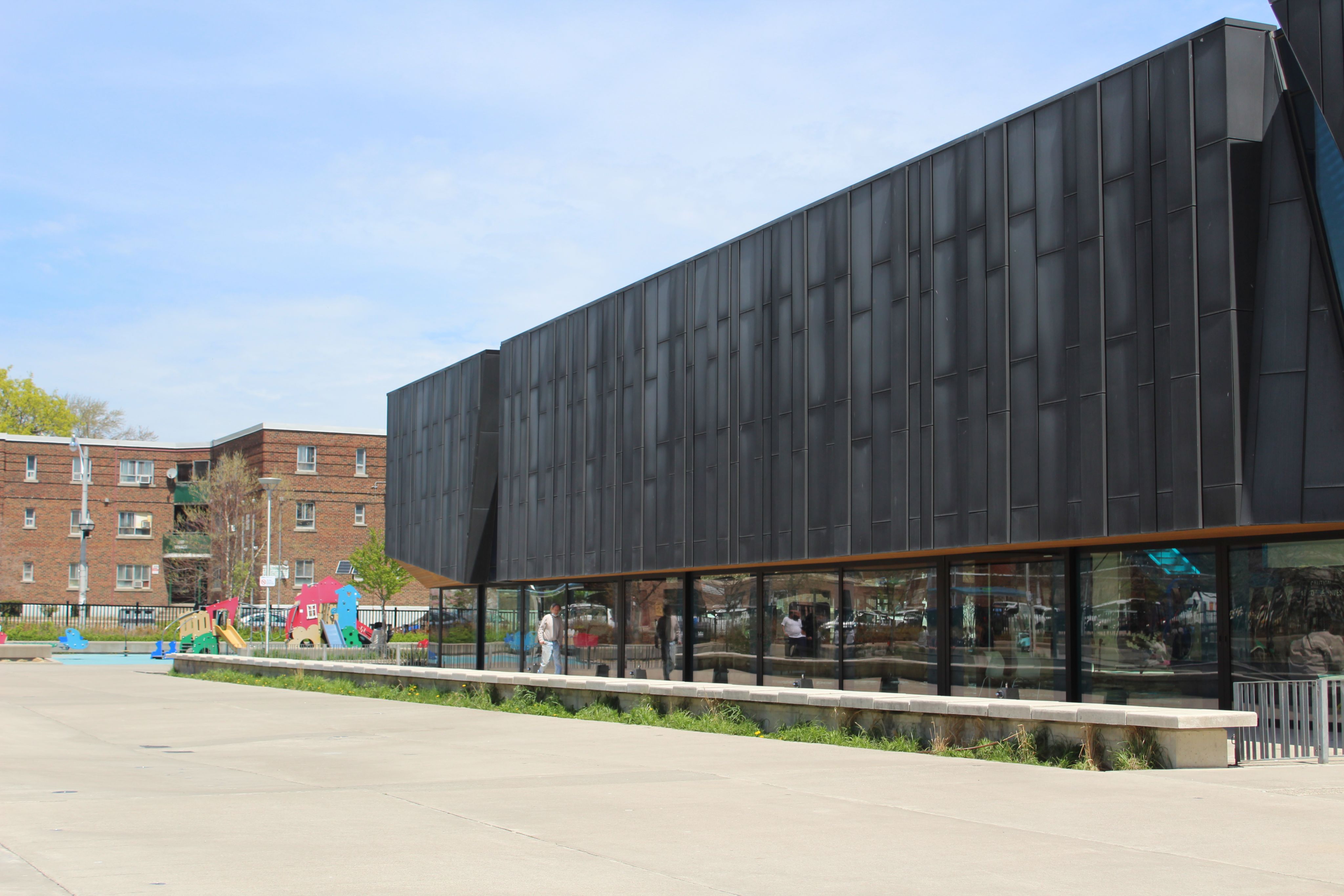 Two buildings are shown - a residential building on the left and the Pam McConnell Aquatic Centre on the right.