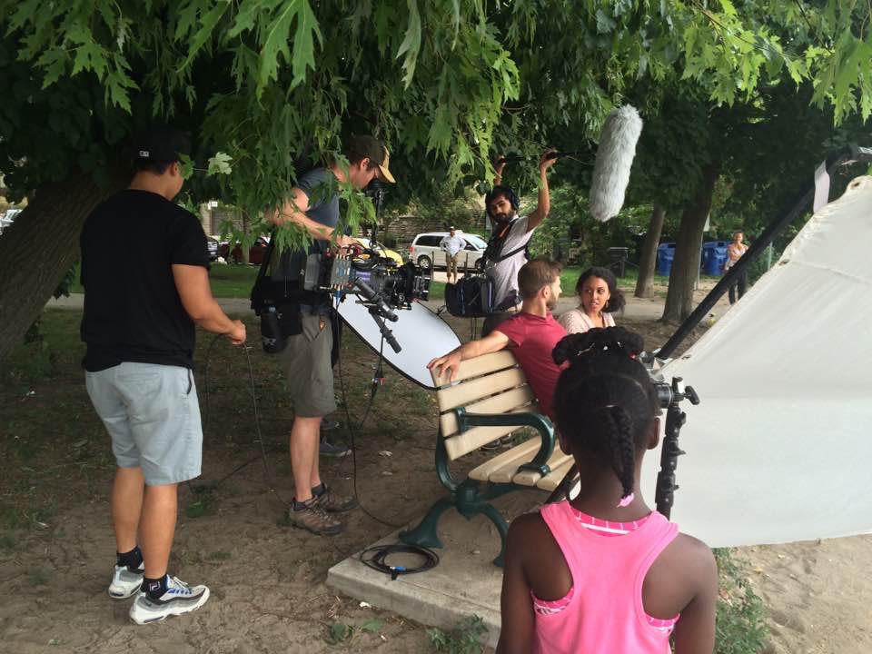People being filmed on a bench