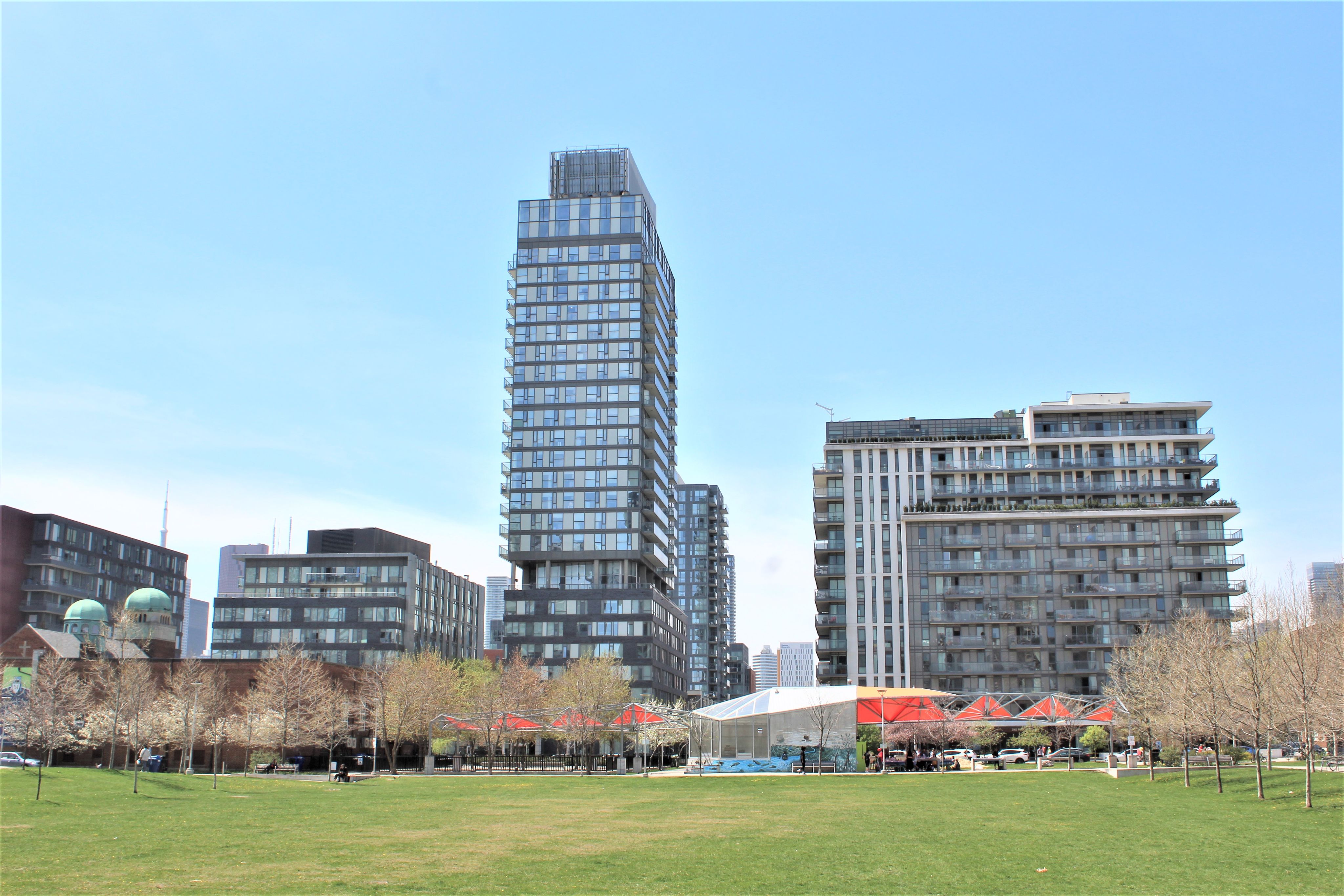 Image of Regent Park - buildings in the background, park in the foreground.