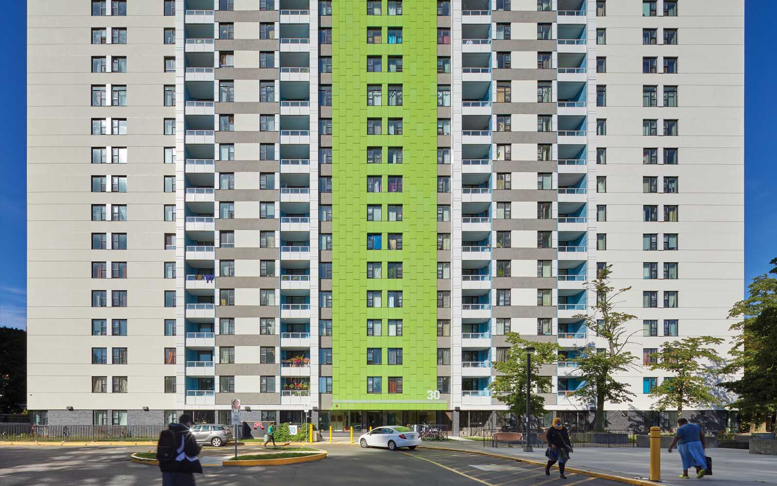 Photo of apartment building at 30 Teesdale Place, the building is mostly white with a bright green stripe down the middle.