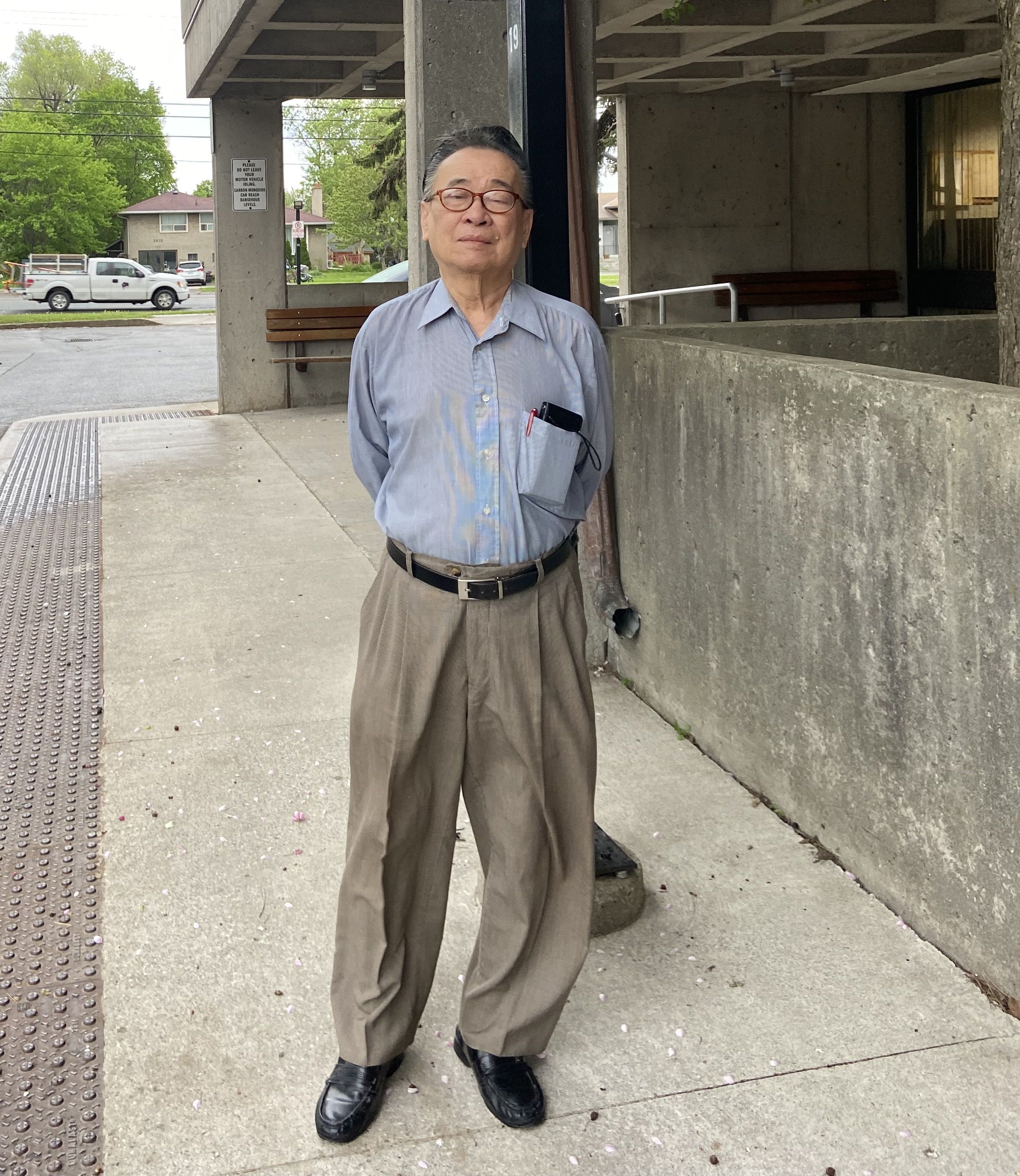 phot of senior tenant leader Edward or standing on the sidewalk uin his neighbourhood