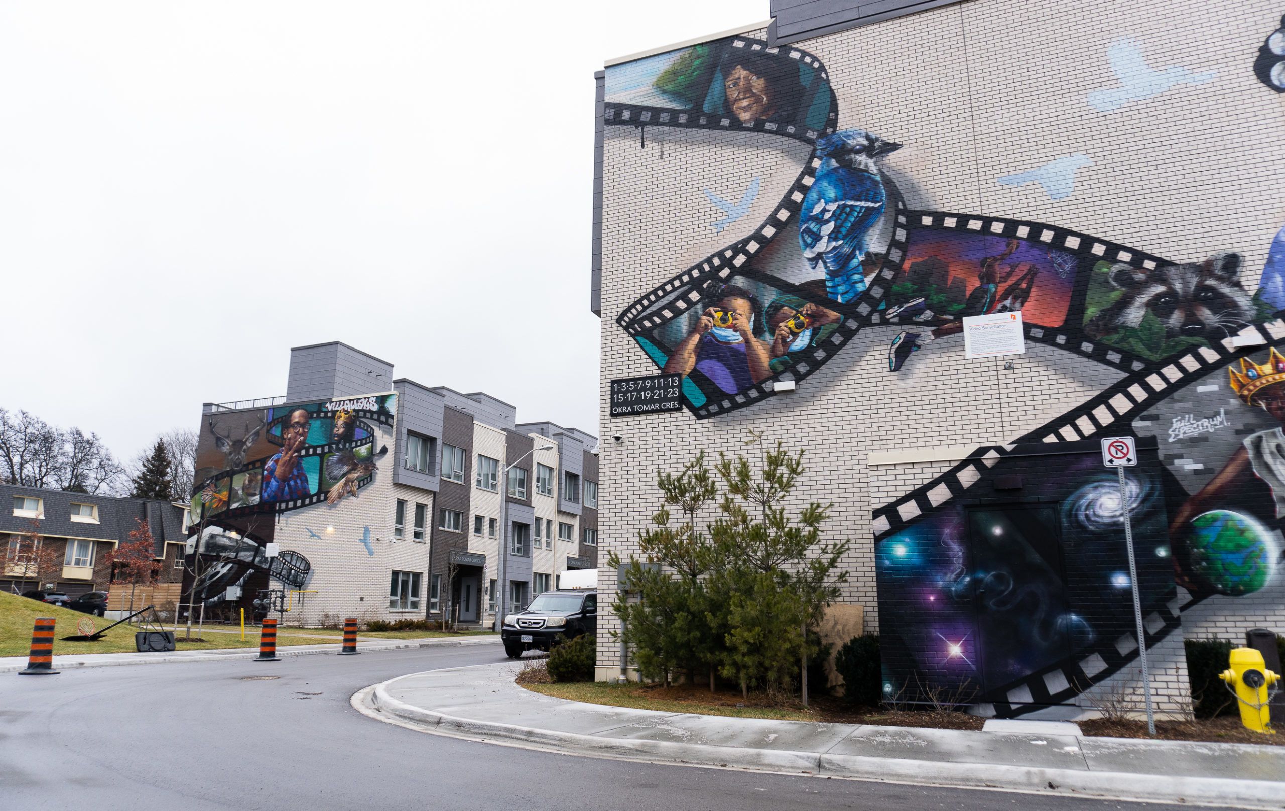 Mural of film roll featuring different aspects of the neighbourhood at Leslie Nymark.