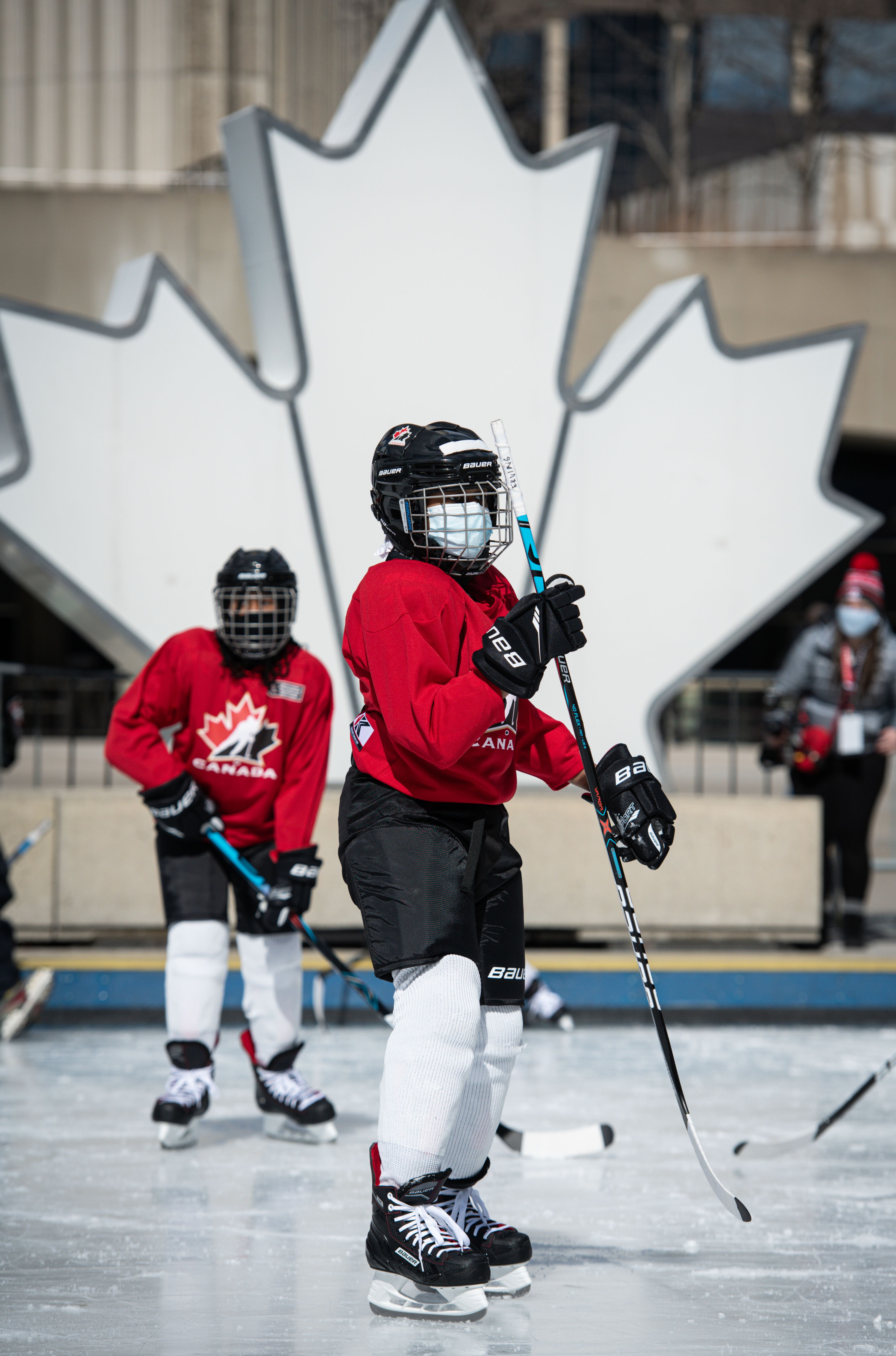 tenant youth on an ice rink dressed in hockey equipment
